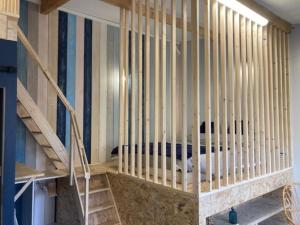 a bedroom with a bed in a wooden cage at Agréable studio proche de Rouen in Le Grand-Quevilly