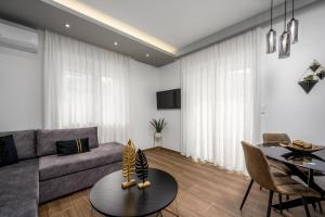 a living room with a couch and a table at Lux City Apartment in Rhodes Town