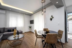 a living room with a couch and a table and chairs at Lux City Apartment in Rhodes Town