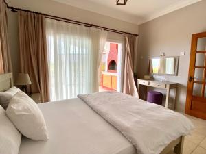 een slaapkamer met een wit bed en een raam bij Lavender Homes, Walled City in Famagusta