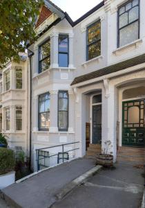 a large white house with a driveway at Near Notting Hill 2 bed Spacious apartment Queens Park Nw6 - QPARK in London