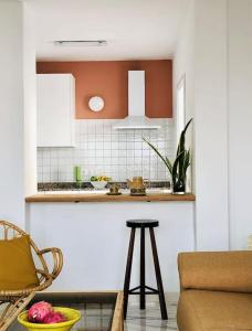 a kitchen with a counter and a stool in a room at Casa Eloína in Playa Honda +5 photos