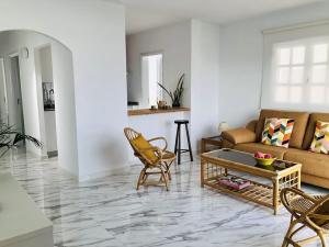 a living room with a couch and a table and chairs at Casa Eloína in Playa Honda