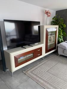 a large entertainment center with a large flat screen tv at Chalet Jamaica 2 in Peñíscola