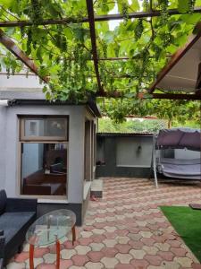 a patio with a couch and a glass table at Vila Madalina in Eforie Sud