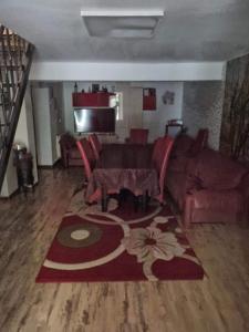 a living room with a couch and a table at Vila Madalina in Eforie Sud