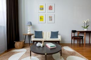 a living room with a coffee table and a couch at Town Hall Hotel - Shoreditch in London