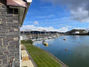 a view of a marina with boats in the water at Portmadog, Oakley Wharf in Porthmadog