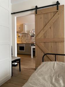 a kitchen with a sliding barn door in a room at Sea & Home in Gąski