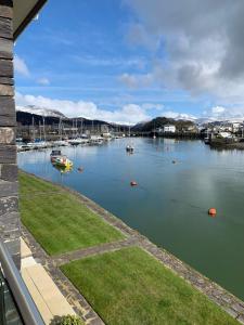 a view of a harbor with boats in the water at Portmadog, Oakley Wharf in Porthmadog