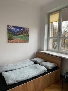 a bedroom with two beds and a window at Classy Rooms in Old Town in Krakow