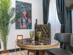a table with two glasses and a bottle of wine at Apartment Art Split center in Split