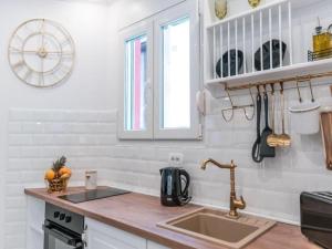 a kitchen with a sink and a clock on the wall at Apartment Art Split center in Split +29 photos