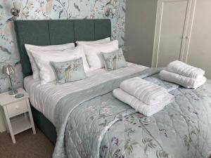 a bedroom with a large bed with white pillows at Assembly View in Ludlow