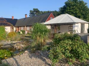 a garden in front of a house at Strandbadsgården B&B in Löderup