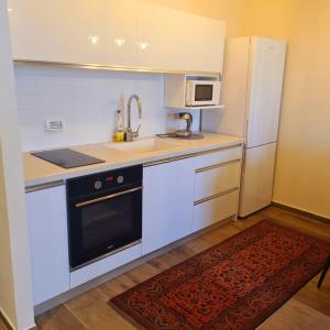 a small kitchen with a sink and a refrigerator at על שפת אגם כנרת in Tiberias