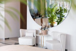 a room with two chairs and a mirror at 1910 Lifestyle Hotel in Volos