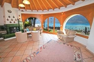 an open living room with a view of the ocean at La Paloma - a79627 in Brione sopra Minusio