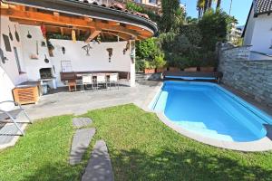 a swimming pool in the yard of a house at La Paloma - a79627 in Brione sopra Minusio