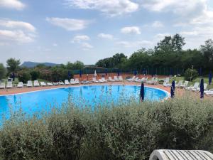 une piscine avec des chaises longues et un complexe hôtelier dans l'établissement Welcome Traveller LOVELY APARTMENTS, à Castion Veronese 12 autres photos