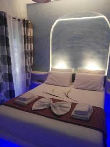 un letto in una stanza con due asciugamani di moments rooms ad Adámas