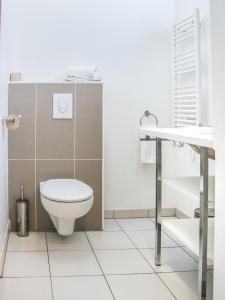 a bathroom with a toilet and a sink at Twenty Business Flats Maisons Alfort Les Juilliottes in Maisons-Alfort