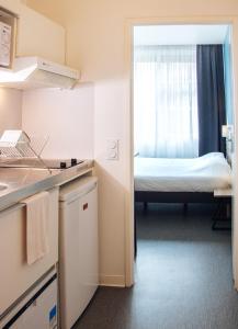 a small room with a bed in the window at Twenty Business Flats Maisons Alfort Les Juilliottes in Maisons-Alfort