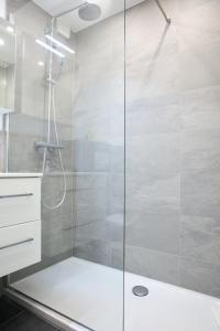 a shower with a glass door in a bathroom at 2.5 Zimmerwohnung für Sportler & Familien WHG 132 & WHG 612 in Täsch