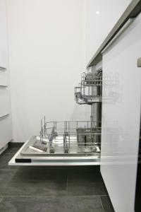 a kitchen with a dish drying rack and a sink at 2.5 Zimmerwohnung für Sportler & Familien WHG 132 & WHG 612 in Täsch