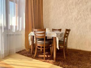 uma mesa de jantar com cadeiras e uma toalha de mesa em Spacious Apartment in New Building, Near the City Center and Airport em Tashkent