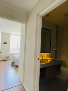 a bathroom with a sink and a mirror at Habitación en miraflores in Lima