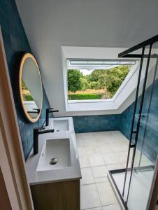 a bathroom with a sink and a mirror at Charming House in the Cabellou on coastal trail in Concarneau