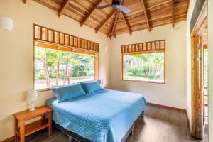 1 dormitorio con cama y ventana en Casa Corazón - Premium Vacation Home, en Puerto Viejo