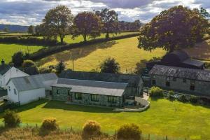 an aerial view of a farm house with a field at The Barn. in Carmarthen