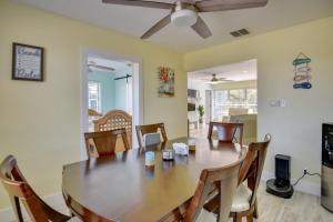 a dining room with a wooden table and chairs at Riverfront Port Orange Home with Dock and Slip! in Port Orange