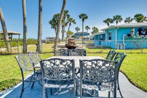 a table and chairs with a statue in a park at Riverfront Port Orange Home with Dock and Slip! in Port Orange