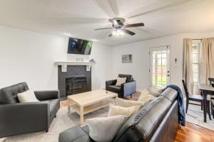 a living room with a couch and a fireplace at Family-Friendly Clarksville Vacation Rental! in Clarksville