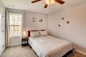 a bedroom with a bed and a ceiling fan at Family-Friendly Clarksville Vacation Rental! in Clarksville