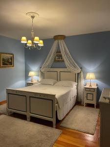 a bedroom with a canopy bed and two night stands at B&B La Bianchina in Monale