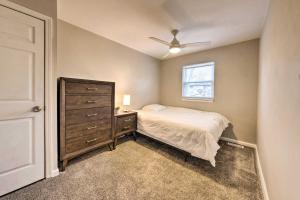 a bedroom with a bed and a dresser and a window at St Charles Vacation Home By Historic District in St. Charles
