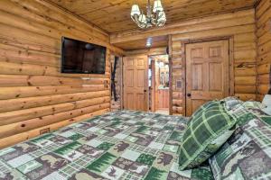 a bedroom with a bed in a log cabin at Rustic Cabin in Roaring River State Park! in Eagle Rock