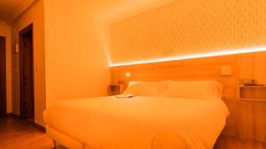 Łóżko lub łóżka w pokoju w obiekcie Hostal Gran Duque