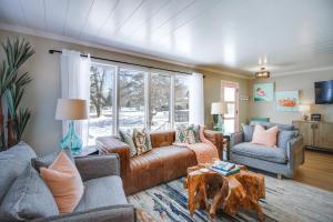 a living room with two couches and a table at Home Rental on Detroit Lake Dock, Game Room! in Detroit Lakes
