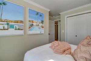 a bedroom with a bed with two pictures on the wall at Home Rental on Detroit Lake Dock, Game Room! in Detroit Lakes