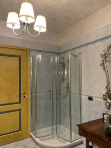 a shower with a glass door in a bathroom at B&B La Bianchina in Monale