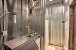 La salle de bains est pourvue d'un lavabo et d'un oiseau sur le mur. dans l'établissement Pheasant Game Farm Missouri Vacation Rental!, 