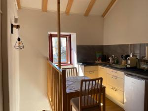 a kitchen with a table and two chairs and a window at Apartment Vesna in Skradin +5 photos