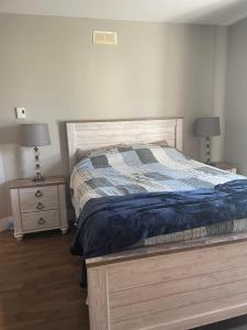 a bedroom with a bed and two night stands at Dominion Place in Moncton