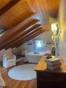 a bedroom with a bed and a desk with books at B&B La Bianchina in Monale