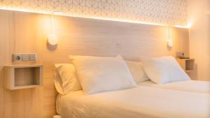 Łóżko lub łóżka w pokoju w obiekcie Hostal Gran Duque